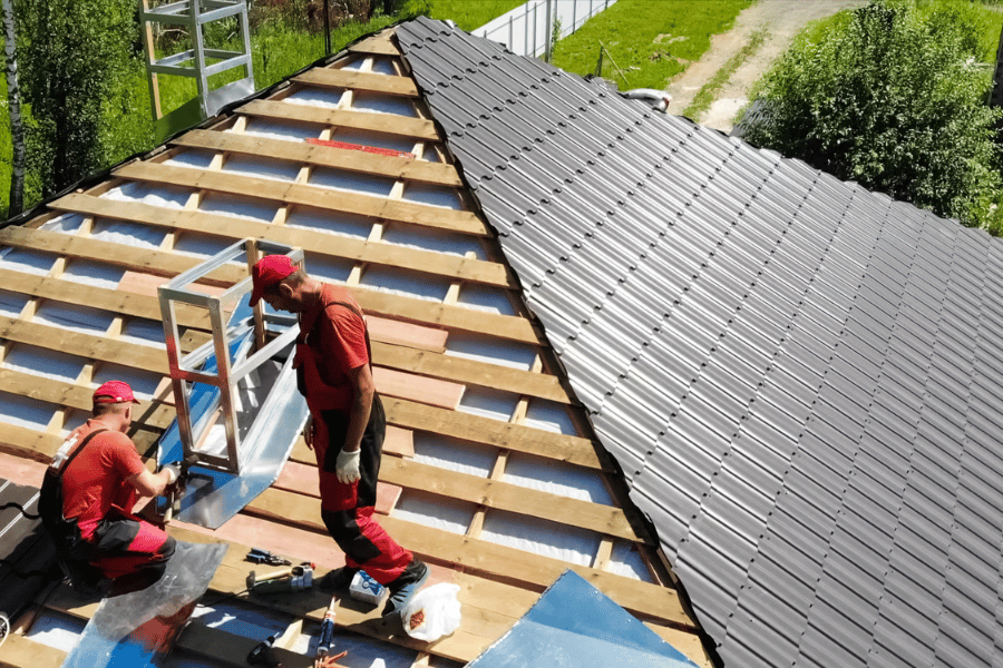 Roofers installing new roofing on a sloped structure